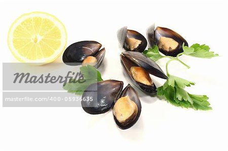 Mussels with parsley and lemon on a white background