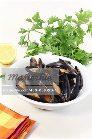 fresh cooked mussels in a bowl with checkered napkin