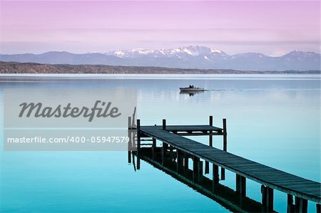 An image of a wooden jetty at the lake Starnberg in Bavaria Germany
