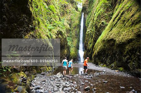 People Hiking in Oneonta Gorge, Oregon, USA People Hiking in Oneonta Gorge, Oregon, USA