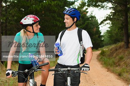 Eau potable couple sur des vélos de montagne