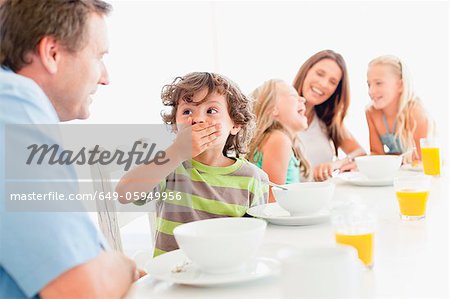 Family talking at breakfast table