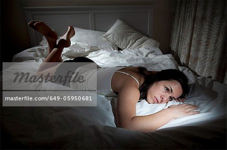 Upset woman lounging in bed