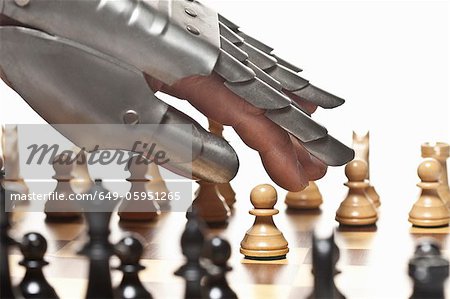 Close up of armored hand playing chess