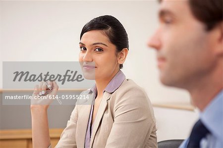 Portrait of a female executive in a meeting