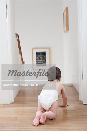 Baby crawling near stairs