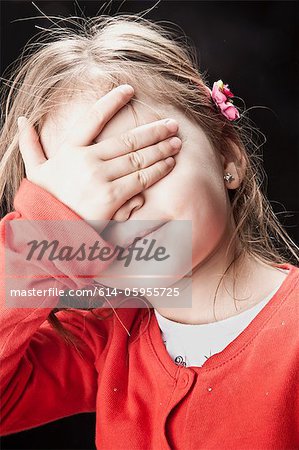 Little girl covering her eyes