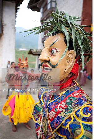 Monk wearing carved wooden mask during traditional performance at the Wangdue Phodrang Tsechu, Wangdue Phodrang Dzong, Wangdue Phodrang (Wangdi), Bhutan, Asia