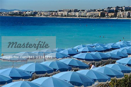 Beach umbrellas viewed from the Promenade des Anglais, Nice, Alpes Maritimes, Provence, Cote d'Azur, French Riviera, France, Mediterranean, Europe