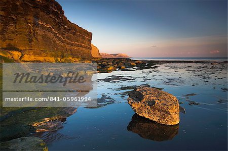 Golden late afternoon sunshine lights up the rocks and cliffs at Kimmeridge Bay, Jurassic Coast, UNESCO World Heritage Site, Dorset, England, United Kingdom, Europe