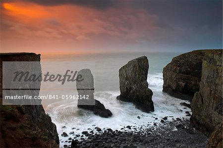 Massive rock stacks guarding the entrance to a secluded Pembrokeshire cove, Elegug Stacks, Pembrokeshire, Wales, United Kingdom, Europe