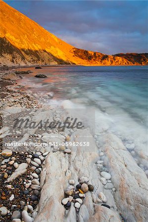 Sunlight glows on the cliffs at Lulworth Cove, Jurassic Coast, UNESCO World Heritage Site, Dorset, England, United Kingdom, Europe