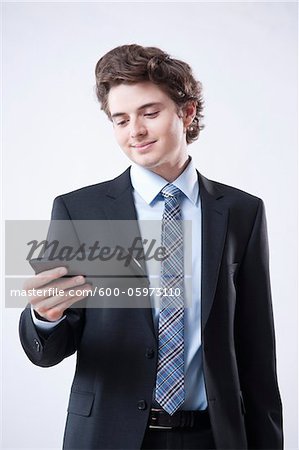 Young Businessman Looking at Digital Tablet