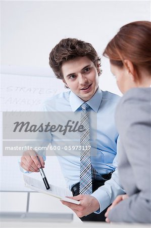 Young Businessman giving Presentation to Businesswoman Young Businessman giving Presentation to Businesswoman