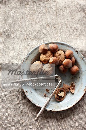 Walnuts and Hazelnuts in Bowl with Nutcracker