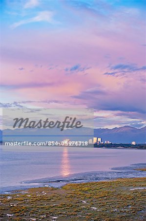 Sunset view of Anchorage city skyline and Knik Arm, Chugach mountains in the background, Southcentral Alaska, Summer