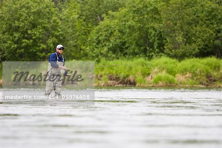 A sportfisherman fishing for salmon on the Mulchatna River in the Bristol Bay region, Southwest Alaska, Summer