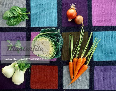 Carrots, onions, cabbage, fennel, spinach and watercress on checkerboard background