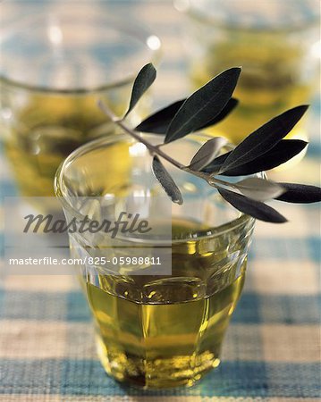Glasses of olive oil with leaves