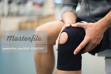 Man wearing knee brace, cropped