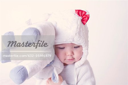 Baby girl hugging stuffed toy