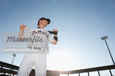 Baseball player holding bat across shoulders