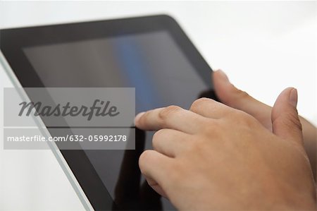 Man using digital tablet, cropped