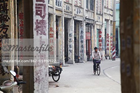 Man riding bicycle along street, Chikanzhen, Guangdong, Guangdong, China