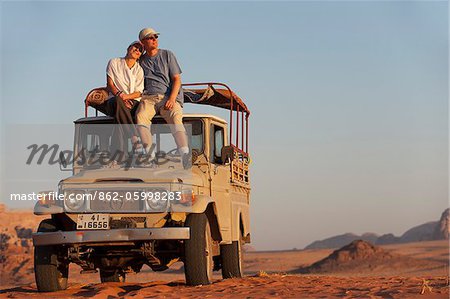 Couple on Jeep in the Wadi Rum, Jordan Couple on Jeep in the Wadi Rum, Jordan