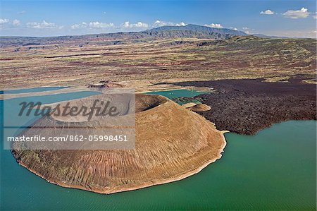 The perfectly shaped volcanic cone called Nabuyatom juts into the jade waters of Lake Turkana.