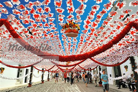 Straßen mit Papierblumen dekoriert. Menschen Festlichkeiten (Festas do Povo). Campo Maior, Portugal