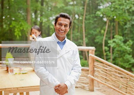 Smiling scientist standing on balcony