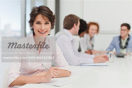 Businesswoman making notes in meeting