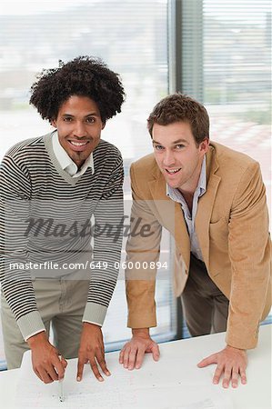 Businessmen smiling in meeting