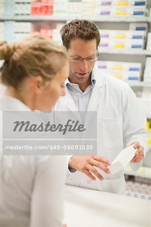 Pharmacist teaching patient about drug