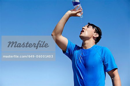 Athlete cooling off with water outdoors