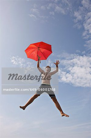 Teenage boy posing in mid-air
