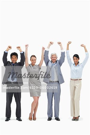 Multicultural business team raising their arms against white background