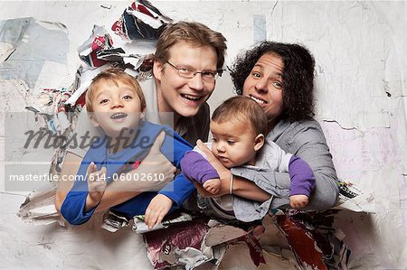 Happy family busting through a wall