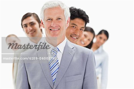 Business people smiling in a single line against white background