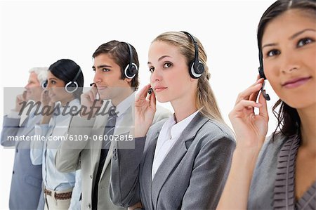 Professionals listening carefully with headsets against white background