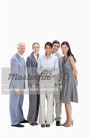 Laughing business team using a touchpad against white background