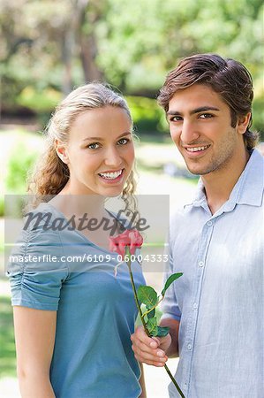 Young couple with a rose in the park