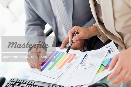 Two business people working on figures in an office
