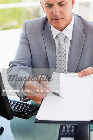 Boss showing a file in a bright office