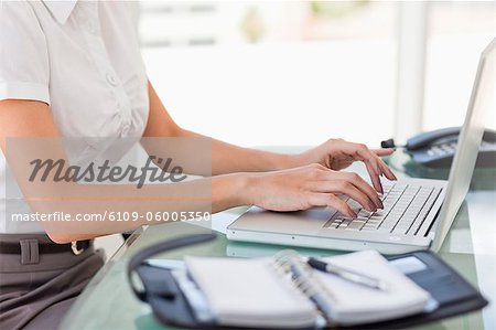 Woman working on a laptop in a bright office