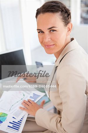 Portrait of a businesswoman working on diagrams in a bright office
