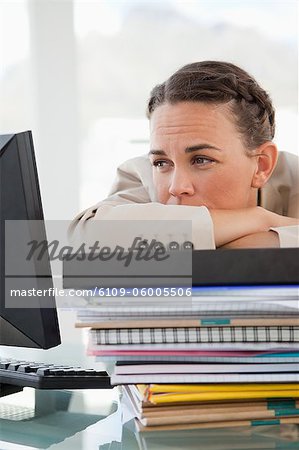 Close-up of a businesswoman with a lot of work in a bright office