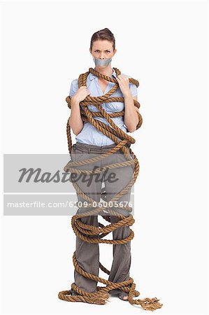 Businesswoman entangled against a white background