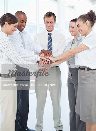 Smiling young tradesteam doing teamwork gesture